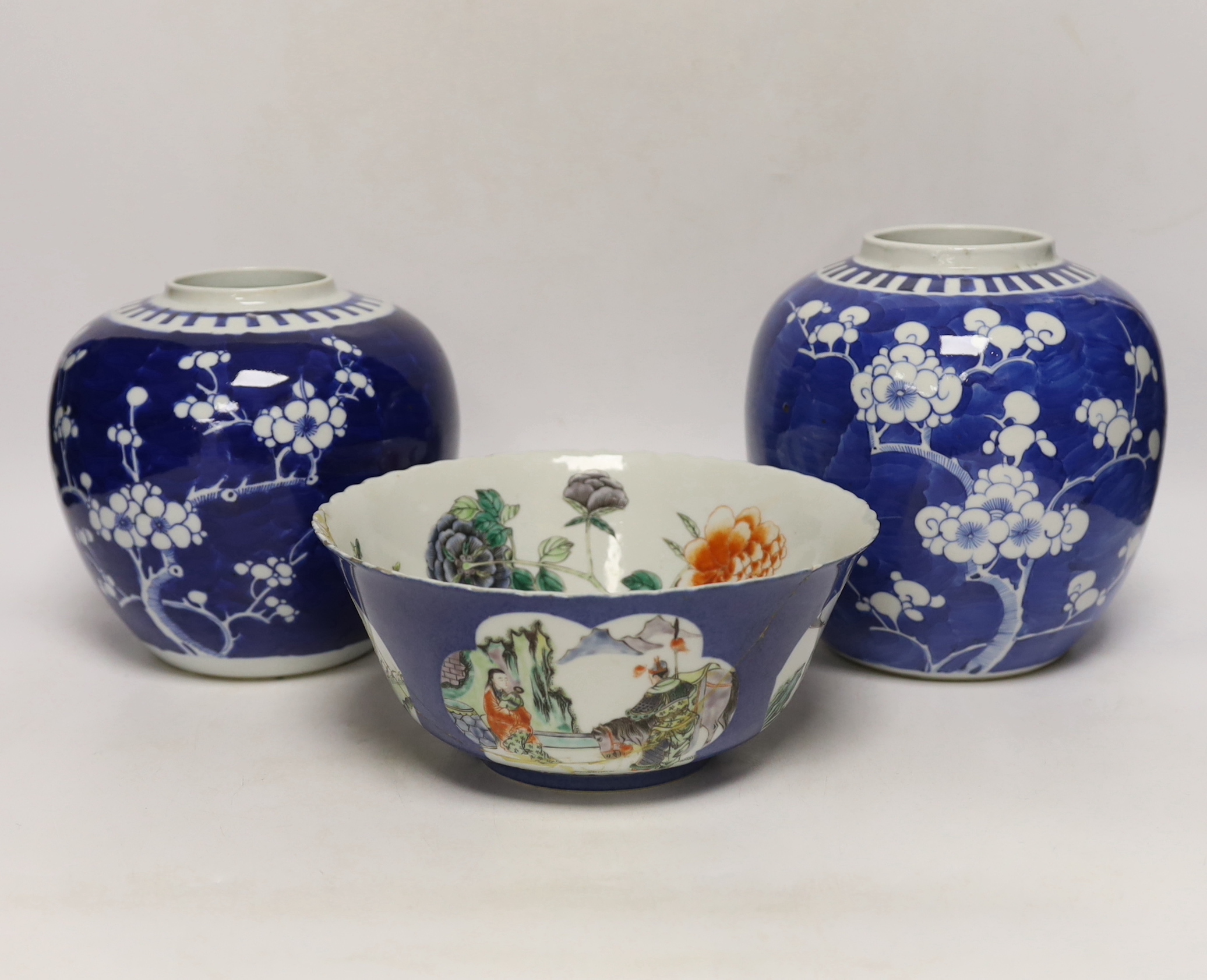 Two Chinese blue and white prunus jars, and a famille verte powder blue bowl, late 19th/early 20th century, tallest 17.5cm